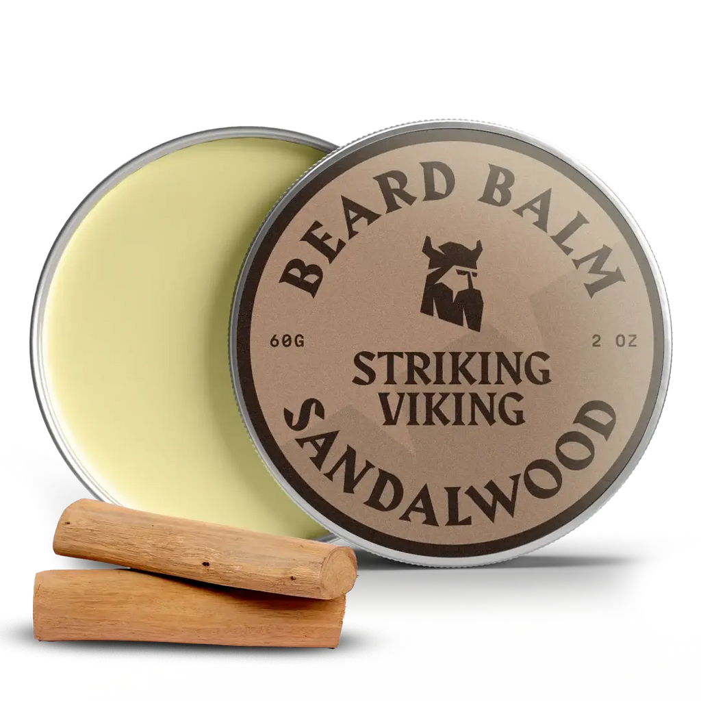 Sandalwood beard balm tin with lid open, two wood pieces beside.