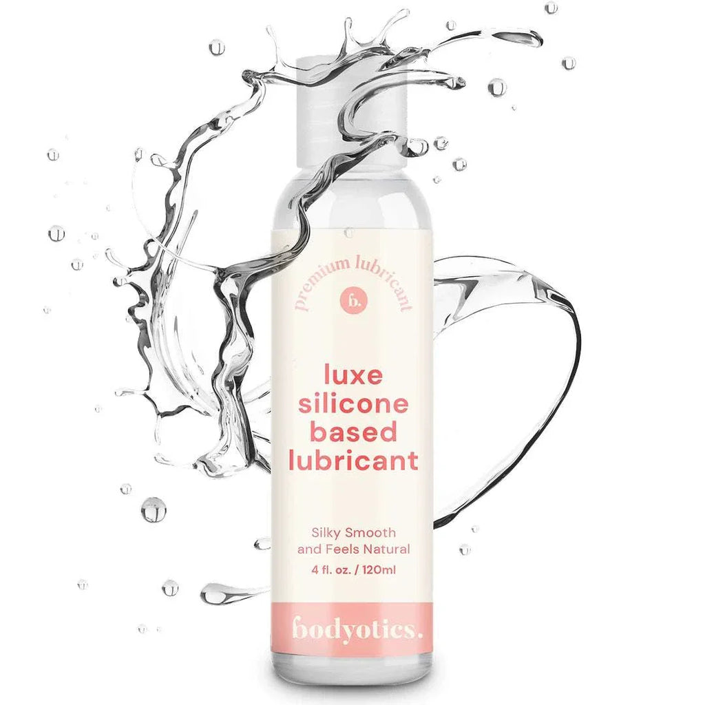 Bodyotics Premium Silicone Based Lubricant 4oz bottle with clear liquid splash, silky smooth and long-lasting formula for sensitive skin and intimate pleasure.