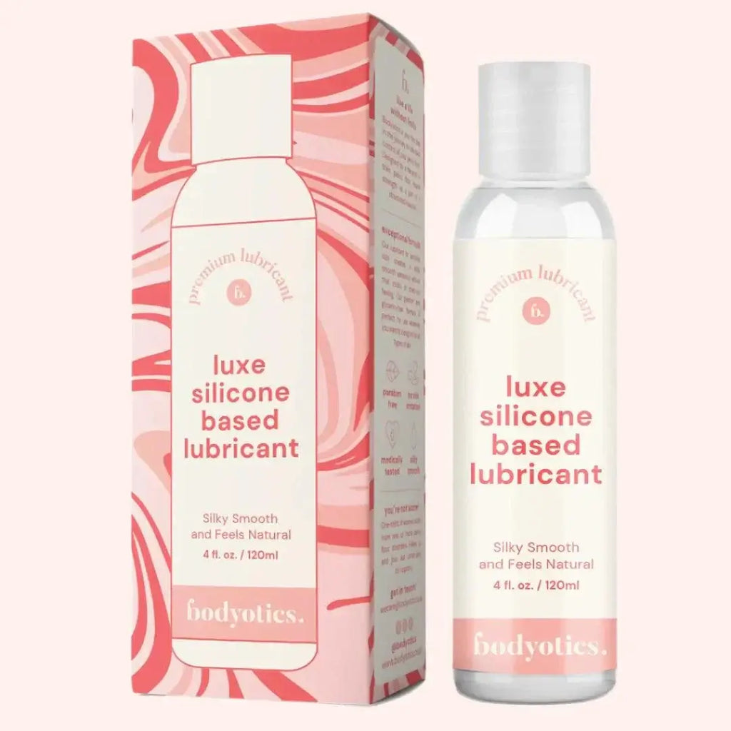 Bodyotics luxe silicone based lubricant bottle and packaging in soft pink tones, 4oz silicone based lubricant for sensitive skin and long-lasting comfort