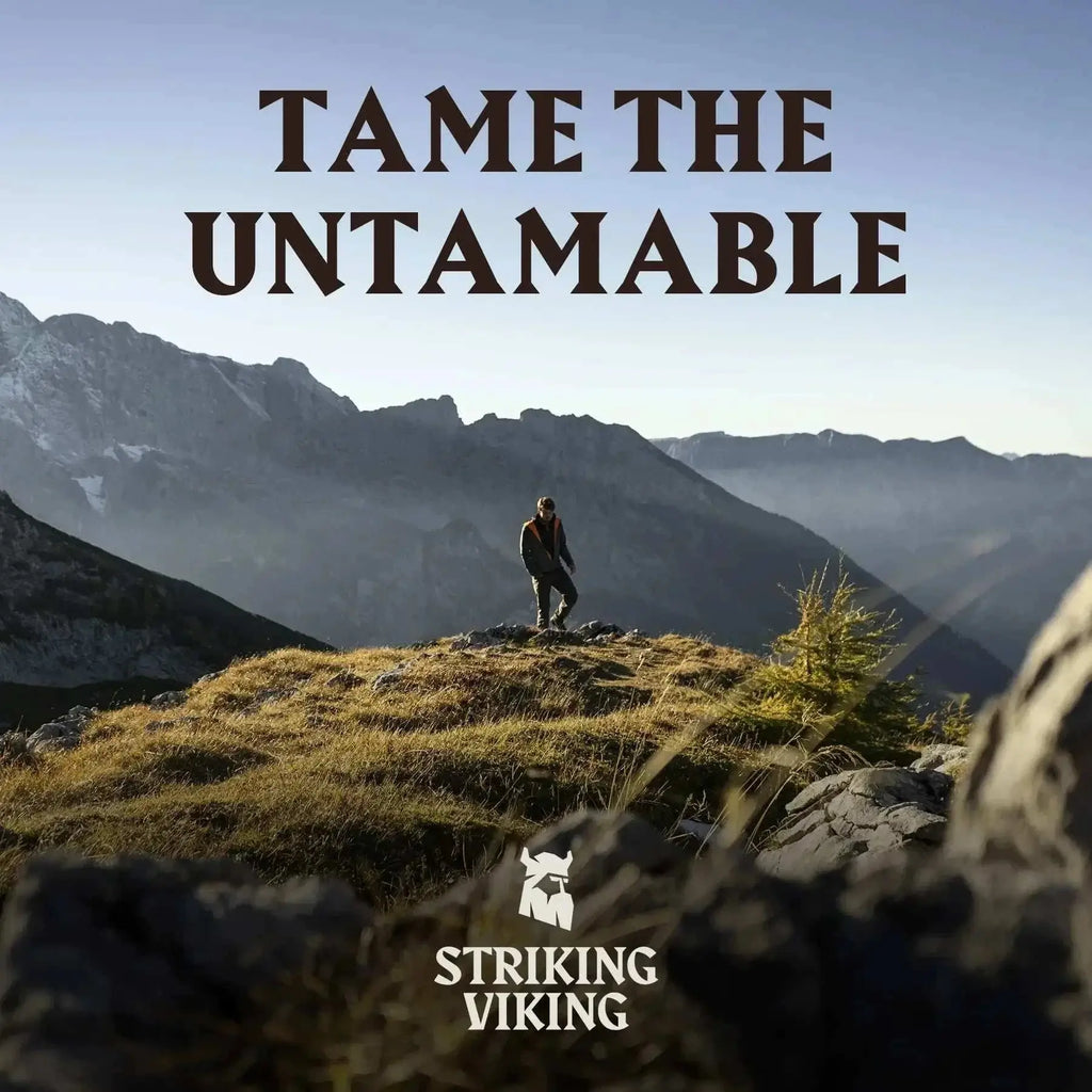 Man standing on a rocky mountain landscape with "Tame the Untamable" text and Striking Viking logo.