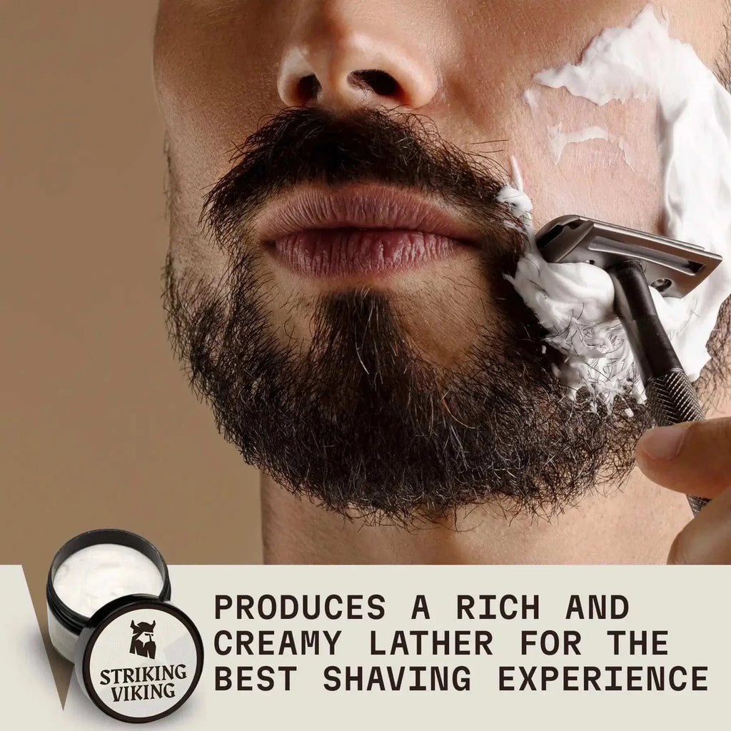 Man applying rich lather of Striking Viking Unscented Shaving Cream for men, ensuring smooth shave.