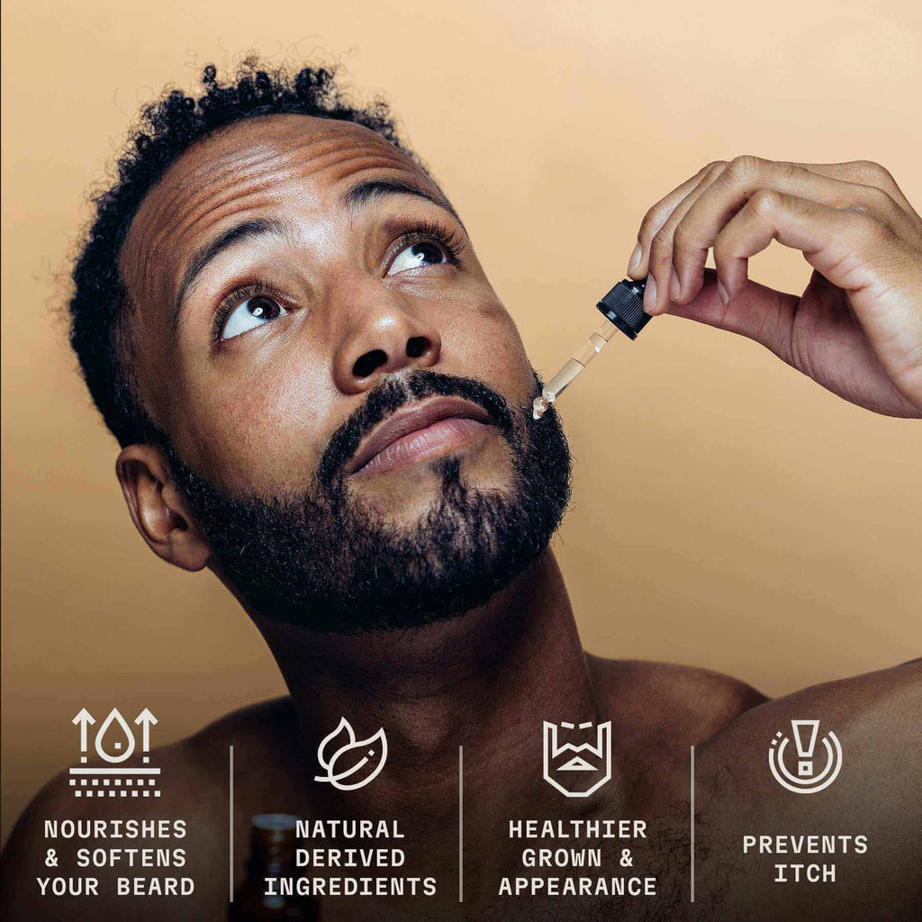 Bearded man using dropper to apply sandalwood beard oil, promotes healthy and soft beard care.